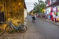 A historic street lined with old rustic weathered heritage houses in the town of Hoi An