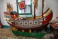 An old vintage antique miniature ship on display at a historic heritage house in the town of Hoi An