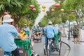 Hoi An, Vietnam: a colorful street of the old town crowded with cycle rickshaws.