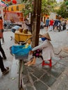 Hoi An, Vietnam - January 24, 2020: Local Vietnamese woman street vendor in market of Hoi An .