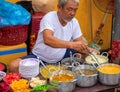 Hoi An, Vietnam - 28 Jul 2019: local eatery with food seller and soup bowl. Vietnamese street food. Old man cook soup