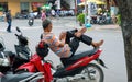 Hoi An, Vietnam - 28 Jul 2019: Man taking rest on motorbike. Scooter driver with smartphone in hands