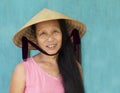 Hoi An, VIETNAM, July 2017 : closeup face portrait of vietnamese woman wearing conical hat