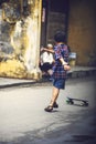 HOI AN, VIETNAM, JUNE 15: A kid skateboarding in the street, on