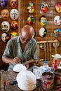 Hoi An, Vietnam - June 2019: man painting traditional Vietnamese masks in his workshop