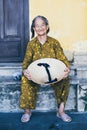 Hoi An, Vietnam - June 2019: old Vietnamese woman with conical hat