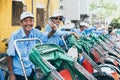 Hoi An, Vietnam - June 2019: Vietnamese rickshaw smiles and shows victory sign with his hand