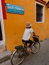 Hoi An, Vietnam: Local riding a bicycle on the colorful streets of Hoi An ancient town. Tourist exploring the