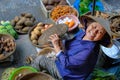 Hoi An / Vietnam, 12/11/2017: Local vietnamese woman smiling and selling vegetables on a traditional street market in Hoi An, Royalty Free Stock Photo