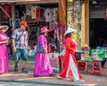 Local women walk downtown in a traditional costume for a woman in Vietnam