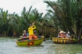 A Vietnamese man is dancing on colorful basket boat