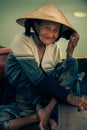 Hoi An, Vietnam. May 05, 2019: Portrait of old smiling Vietnamese lady in conical hat