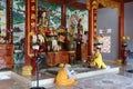 Two Buddhist monks pray next to the altar dedicated to Buddha in the upper prayer hall of the Chua Nhon An Temple. Hoi An, Vietnam