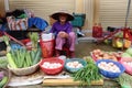 A woman at a small stall in the Ba Le market in Hoi An