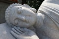 Detail of the face of the granite sculpture of the Reclining Buddha in the garden of the Chua Van Duc Temple in Hoi An