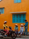 Hoi An, Vietnam, Vietnamese local women friends talking to each other.