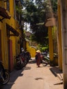 HOIAN, VIETNAM, SEPTEMBER, 04 2017: Matocycles parket in a path with old houses,in Hoi An ancient town, UNESCO world