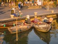 HOIAN, VIETNAM, SEPTEMBER, 04 2017: Unidentified people in the traditional boats in front of ancient architecture in Hoi