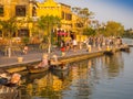 HOIAN, VIETNAM, SEPTEMBER, 04 2017: Unidentified people in the traditional boats in front of ancient architecture in Hoi