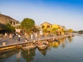 HOIAN, VIETNAM, SEPTEMBER, 04 2017: Unidentified people in the traditional boats in front of ancient architecture in Hoi