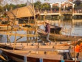 HOIAN, VIETNAM, SEPTEMBER, 04 2017: Unidentified people in the traditional boats in front of ancient architecture in Hoi