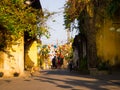 HOIAN, VIETNAM, SEPTEMBER, 04 2017: Unidentified people walking in the street with some green and red lanterns hanging Royalty Free Stock Photo