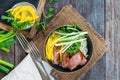 Hoisin duck with mango, spring onion, rocket lettuce salad and rice