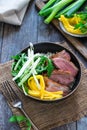Hoisin duck with mango, spring onion, rocket lettuce salad and rice