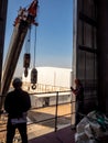 Hoist of crane at the window of industrial plant