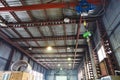 Hoist with overhead crane and scales in warehouse Royalty Free Stock Photo