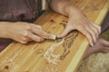 Hojbjerg, Denmark, August, 2022: Girl carving wood at viking festival