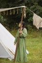 Hojbjerg, Denmark,July 29,2023: girl sets up a tent at Viking festival