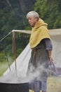 Hojbjerg, Denmark, July 29, 2023: Woman at the Viking festival boils clothes in herbs