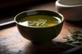 Hojicha tea. A bowl of green liquid with the word olive on it AI generation