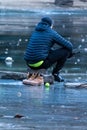 Hokey player sitting on the frozen lake Royalty Free Stock Photo