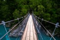 Hokitika Gorge, West Coast, New Zealand. Beautiful nature with blueturquoise color water and wooden swing bridge Royalty Free Stock Photo