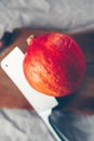 Hokkaido pumpkin with cleaver on wooden background Royalty Free Stock Photo