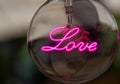 light bulb with the word love written in neon Royalty Free Stock Photo
