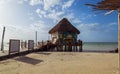 HOLBOX-QUINTANA ROO-MEXICO-AUGUST-2021: Pier made of wood and with a beautiful mural in which small tourist boats go out to the