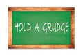 HOLD A GRUDGE text written on green school board