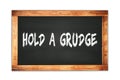 HOLD A GRUDGE text written on wooden frame school blackboard