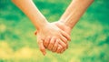 Hold on, hands, couples. Couple hold hand in the autumn or summer park. Closeup of loving couples holding hands while Royalty Free Stock Photo