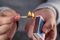 Hold a matchbox while striking a match Royalty Free Stock Photo