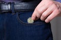 Hold a new tenge coin. Put a coin in jeans pocket. Close up. New Kazakhstan coin 200 tenge. Money, Bank, save, spend