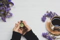 Hold the old pocket watch in the hands of a coffee cup on a wooden table Royalty Free Stock Photo