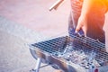 Hand hold tongs and ferret charcoal fire Royalty Free Stock Photo