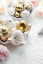 Holder with Easter eggs painted golden colors on a white wooden background Royalty Free Stock Photo