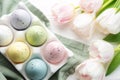Holder with Easter eggs painted pastel colors on a white wooden background Royalty Free Stock Photo