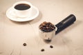 holder filled with beans and coffee cup/ holder filled with beans and coffee cup on a concrete background Royalty Free Stock Photo