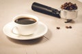 Holder filled with beans and coffee cup/holder filled with beans and coffee cup on a concrete background, selective focus Royalty Free Stock Photo